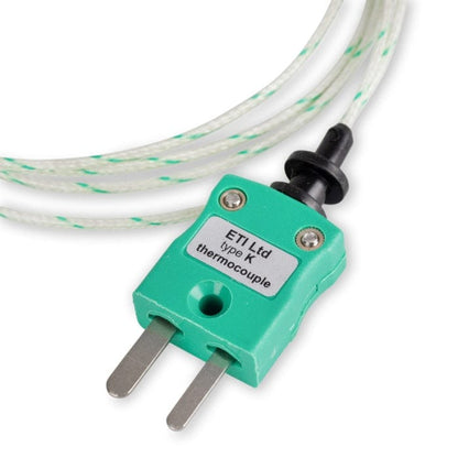 Une sonde de température de four verte en fibre de verre avec un fil, utilisée pour mesurer la température dans les fours.
