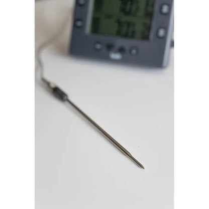 une Sonde de pénétration pour DOT ou ChefAlarm de Thermometre.fr sur une table à côté d'une horloge.